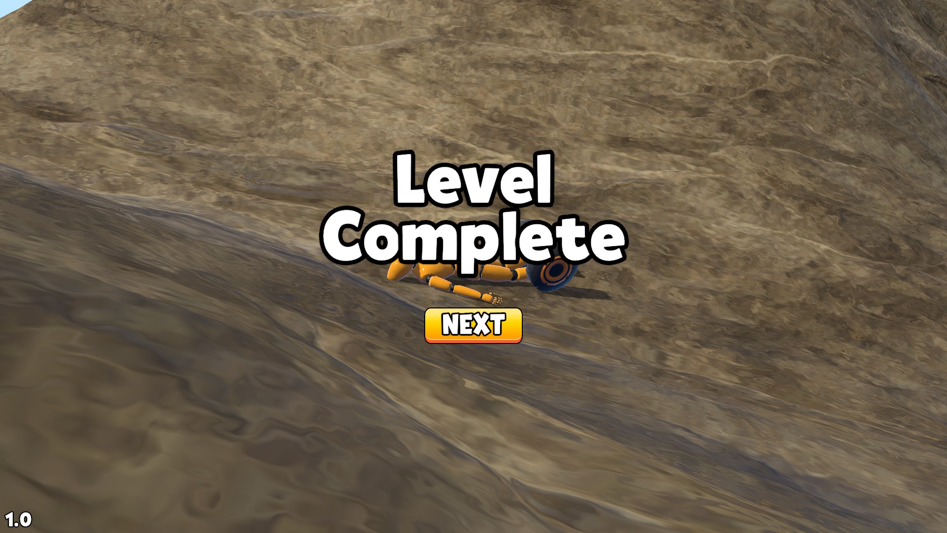 Level Complete message and yellow Next button over a ragdoll on the rocky course in Ragdoll Racing: Extreme Downhill!
